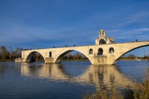 A beautiful shot of an Avignon Bridge in France with a blue sky in the background